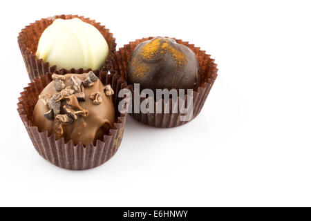 Chocolate pralines with almond, cinnamon and champagne liqueur isolated on white background Stock Photo