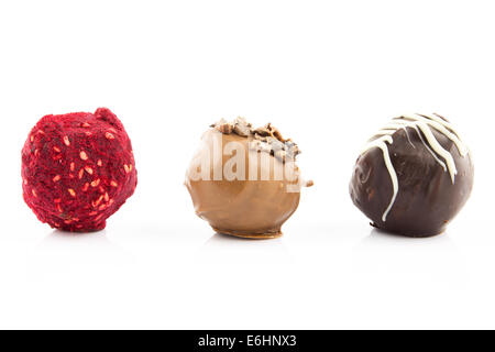 Chocolate pralines with almond, honey, brandy liqueur and raspberry powder isolated on white background Stock Photo