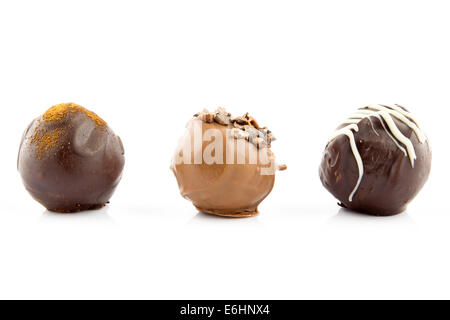 Chocolate pralines with almond, cinnamon and champagne liqueur isolated on white background Stock Photo