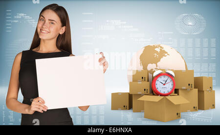 Businesswoman with Earth, alarm clock and cardboard boxes Stock Photo