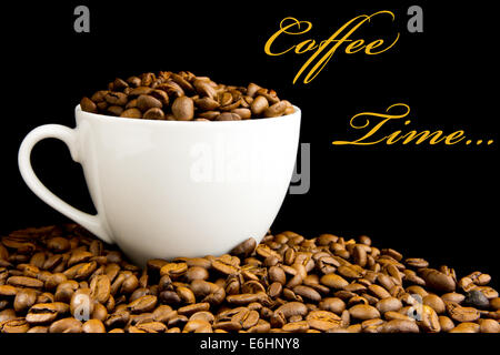 Cup filled with coffee beans on black background Stock Photo