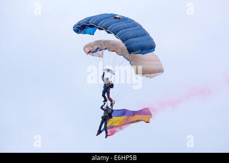 Dunsfold, UK. 23rd Aug, 2014. The Tigers Freefall Parachute Display Team, seen here, are the flagship team for the Princess of Wales's Royal Regiment, whose seniority stems from the Tangier Regiment of 1661 and thus has the distinction of being the senior English Infantry Regiment of the line. Soldiers of the Regiment are recruited from Kent, Surrey, Sussex, London, Hampshire, Isle of Wight and the Channel Islands. Members of The Tigers consist of volunteers from various battalions of the regiment. The Tigers perform displays throughout the country the majority of which would be carried out wi Stock Photo