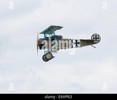 Dunsfold, UK. 23rd Aug, 2014. Dunsfold aerodrome in Surrey holds an annual motor and airshow over the August Bank Holiday weekend.  Here replica Great War German Fokker Triplane fighter takes part in a 'dogfight' with other members of the Great War Display Team Credit:  Niall Ferguson/Alamy Live News Stock Photo