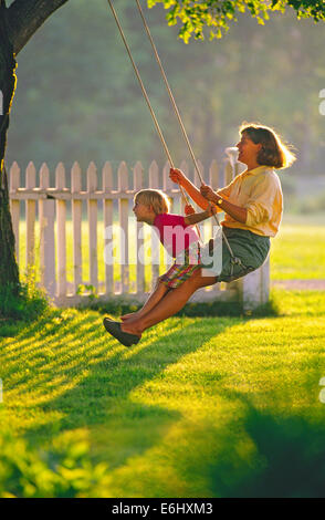 Bucky and Laurie Brownell  (R) on swing Stock Photo