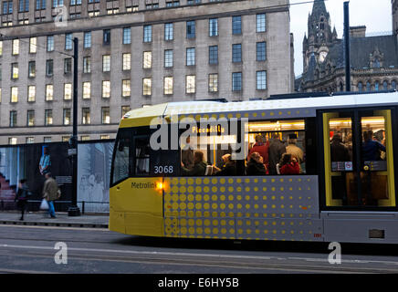 Yellow Manchester trams at dusk, England, UK