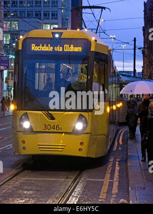 Yellow Manchester trams at dusk, England, UK Stock Photo