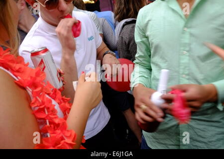 London, UK. 24th August, 2014. Notting Hill Carnival 2014. The drug of choice at Carnival seemed to be Nitrous Oxide taken via balloon. Credit:  Rachel Megawhat/Alamy Live News Stock Photo