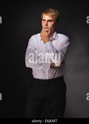Casual and handsome modern businessman wearing black suit and white shirt, studio shot dark background Stock Photo