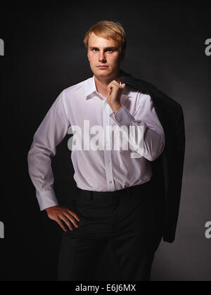 Casual and handsome modern businessman wearing black suit and white shirt, studio shot dark background Stock Photo
