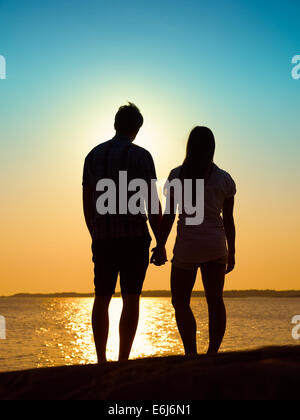 In love young couple enjoying the sunset together, beautiful evening in archipelago Stock Photo