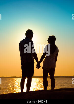 In love young couple enjoying the sunset together, beautiful evening in archipelago Stock Photo