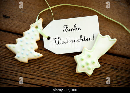 The German Words Frohe Weihnachten, which means Merry Christmas, on a Label with Cookies Stock Photo