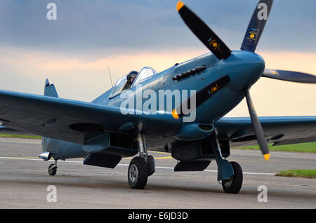 The Battle of Britain Memorial Flight's photo recon Spitfire taxies into RAF Scampton, Lincs., for the sunset memorial. Stock Photo