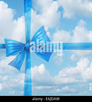 Dream gift from a fantasy wish list concept as an imaginary silk ribbon and bow on a sky background as a symbol of dreaming of holiday hopes for a merry Christmas and a joyful newyear. Stock Photo