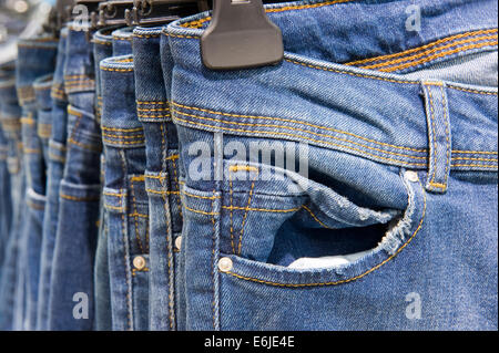 New blue jeans hanging in a shop Stock Photo