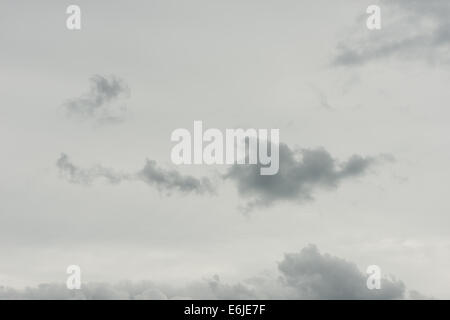 skyscape of dramatic dark puffy cotton wool clouds of layered cumulus developing into cumulonimbus higher altostratus Stock Photo