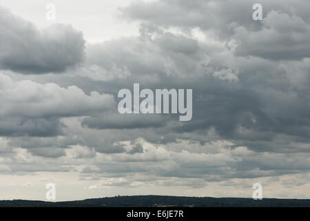 skyscape of dramatic puffy cotton wool clouds of layered cumulus stratocumulus developing into cumulonimbus higher altostratus Stock Photo