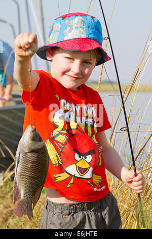 Young boy holding bream fish he caught on the Lower Zambezi River Stock Photo