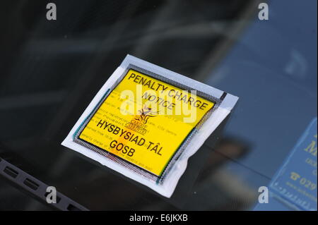 A Welsh Penalty Charge Notice (PCN) parking ticket on a car windscreen issued in Cardiff, Wales. Stock Photo