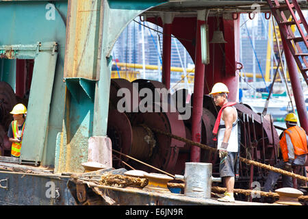 The Barge Master. Foreman On A Derrick Barge In The Causeway Bay Typhoon Shelter, Hong Kong. Stock Photo