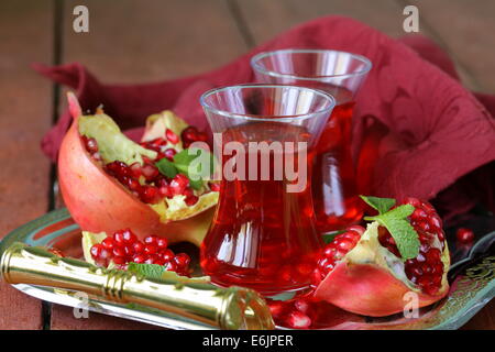 pomegranate fruit tea in traditional glass cups Stock Photo