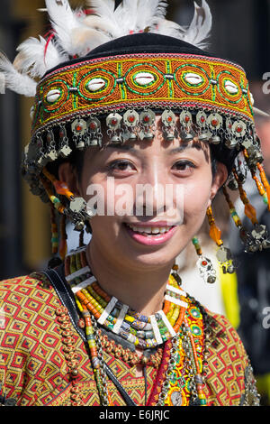 Female member of the Taiwan Contemporary Dance group, in the national costume, doing a street performance in Edinburgh Stock Photo