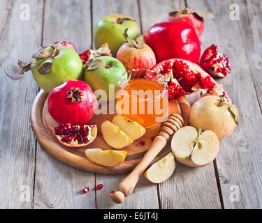 Pomegranate, apple and honey, traditional food of jewish New Year celebration, Rosh Hashana. Selective focus. Stock Photo