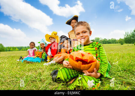 Group of kids in Halloween costumes sitting Stock Photo
