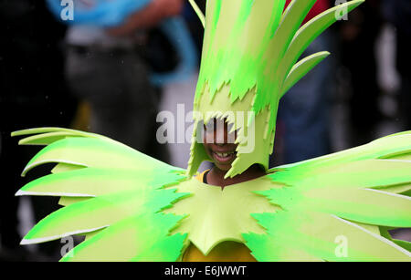 London, UK. 25th Aug, 2014. A performer dances during the Notting Hill Carnival in London, Britain on Aug. 25, 2014. Over 1 million visitors are expected to attend the two-day event which is the largest of its kind in Europe. The event has taken place on the West London streets every August Bank Holiday weekend since 1964. © Han Yan/Xinhua/Alamy Live News Stock Photo