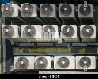 view from above a bank of industrial Air conditioning units at the rear of a large hotel Stock Photo