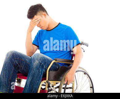 depressed and handicapped man sitting on a wheelchair Stock Photo