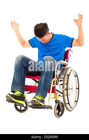 depressed and angry man sitting on a wheelchair Stock Photo