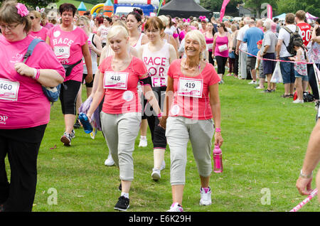Mother and daughter holding hands on a Race-for-Life event  England UK Stock Photo