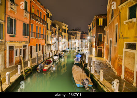 Canal with boats and colourful houses at night, Venice, Veneto, Italy Stock Photo