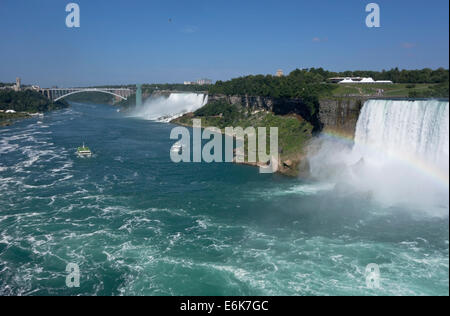 View of American and Canadian (Horseshoe) Falls in Niagara Falls. 'Maid of the Mist' boats carry tourists towards the Falls. Stock Photo