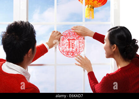Young couple decorating on Chinese New Year Stock Photo