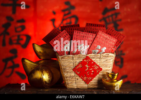 Close-up of gold ingots and red envelopes Stock Photo