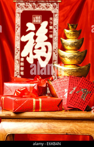 Close-up of gold ingots and red envelopes Stock Photo