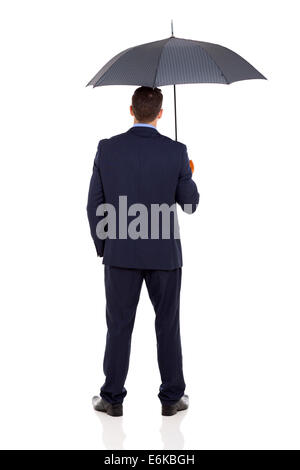 rear view of businessman with an umbrella on white background Stock Photo