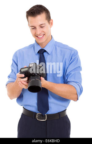 handsome photographer checking photos on his camera isolated on white background Stock Photo