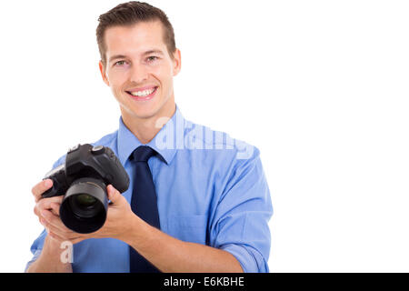 handsome young photographer holding a camera on white background Stock Photo