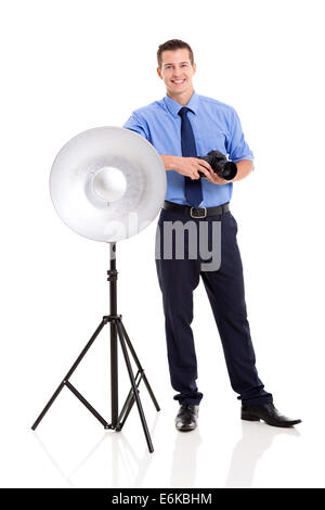 happy male photographer in studio standing next to beauty dish Stock Photo
