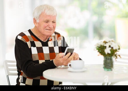 happy senior man using smart phone at home Stock Photo