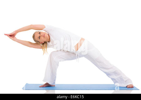 flexible mid age woman doing yoga exercises isolated on white Stock Photo