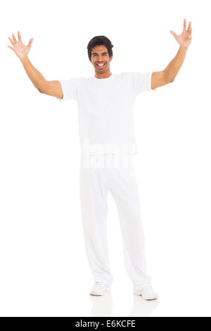 happy young Indian man with arms up on white background Stock Photo