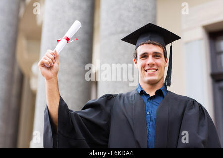 happy male university student holding his graduation certificate Stock Photo