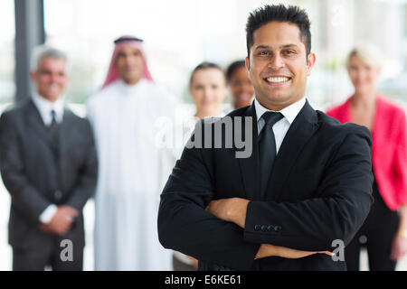 cheerful young Indian businessman with team on background Stock Photo