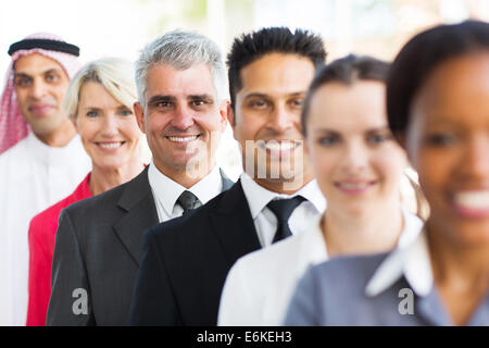 senior businessman standing in a row with colleagues Stock Photo