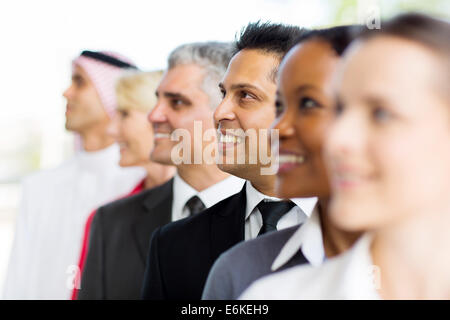 Indian businessman standing in a row with co-workers Stock Photo