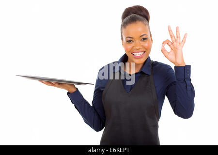 cute young African American waitress giving ok hand sign isolated on white Stock Photo